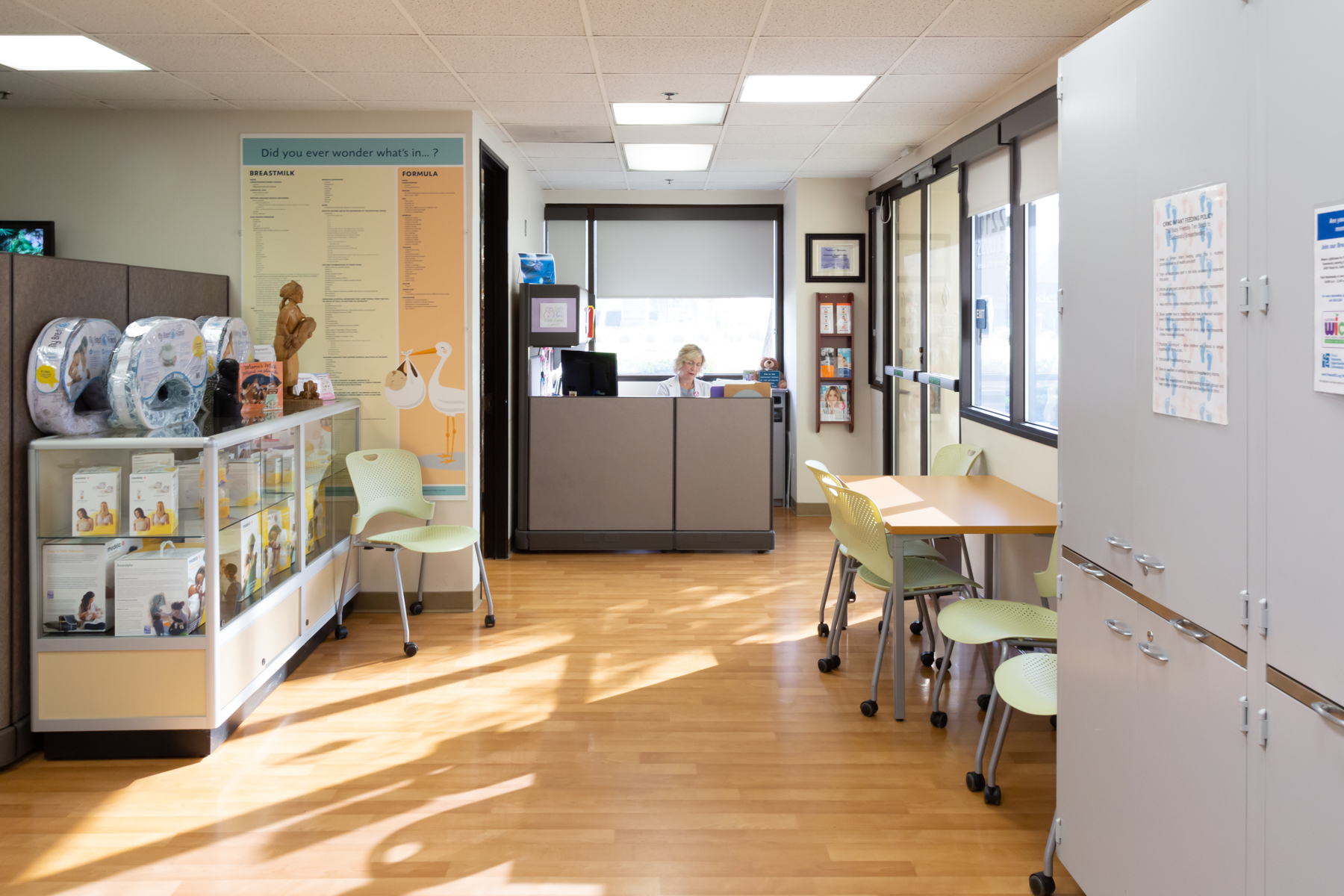 Interior of the Mother's Resource Center showing a reception desk, informational posters on the wall, and breastfeeding products in a glass case.