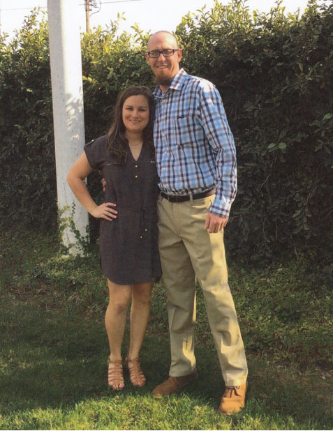 Jacob Jackson and his wife stand together in their backyard